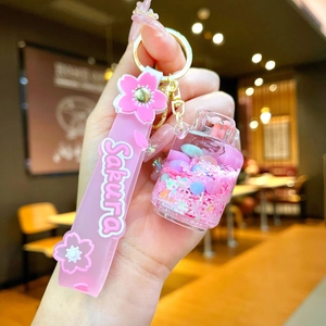 Cute pink Sakura gas bottle liquid glitter keychain with silicone hand strap for bags