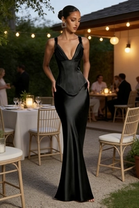 Detail of elegant black satin evening dress with structured corset top and mermaid hem
