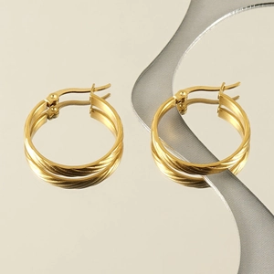 18k gold-plated round hoop earrings with twist rope texture on a reflective surface
