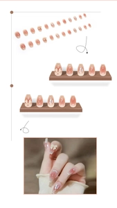 Detail of pink gradient press-on nails with 3D bows, pearls, and silver foil accents