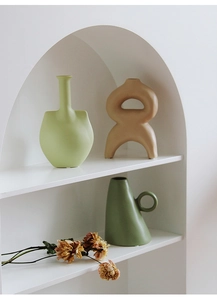 Modern Morandi ceramic vases with matte texture in a white minimalist niche setting
