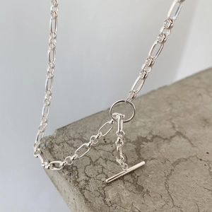 Detail of 925 sterling silver pearl necklace with OT toggle clasp on stone