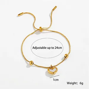 Detailed view of adjustable golden heart bracelet with 24cm chain and polished beads