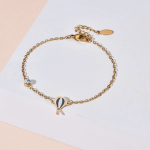 Minimalist gold stainless steel bracelet featuring a hot air balloon and zircon pendant