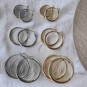 Classic thick hoop earrings in gold and silver, available in small, medium, and large sizes