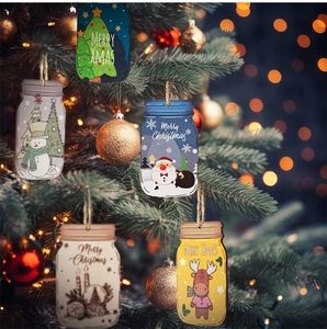 Close-up of five wooden mason jar ornaments hanging on a lighted Christmas tree