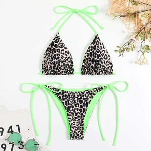 Flat lay of sexy leopard print bikini set with neon green ties and matching sunglasses