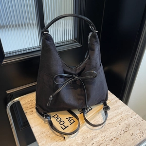 Vintage black faux suede tote bag with leather straps and decorative bow detail