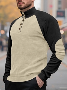 Detail of men's color-block knit sweater featuring retro buttons and elbow patches