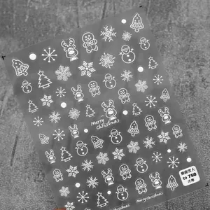 Detailed 5D embossed Christmas nail stickers featuring white snowflakes and reindeer