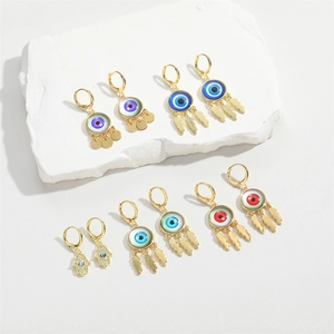 Evil eye and Hamsa hand gold dangle earrings with colorful enamel and fringe charms