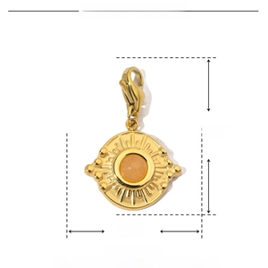 Detail of 26mm gold stainless steel sunburst pendant with natural stone and lobster clasp