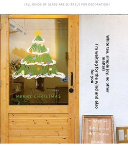 Detail of hand-drawn Christmas tree window sticker on shop glass door