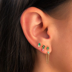Close-up of vintage flower zircon earrings with long chain tassels and green gemstones