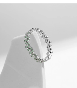 Detail of s925 silver ring featuring green enamel flowers and sparkling diamonds