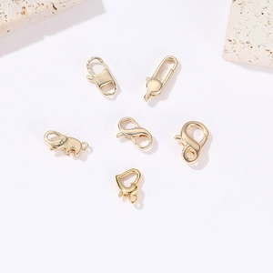 Variety of 14k gold plated lobster clasps in heart and elephant shapes for DIY jewelry making