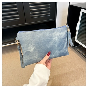Blue denim texture clutch bag featuring a stylish fringe tassel and sturdy side wristlet