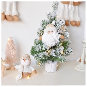Detail of knitted Santa and reindeer plush ornaments with pine tree Christmas decor
