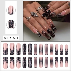 Long trapezoid press-on nails with pink base, black leopard print, and rhinestones