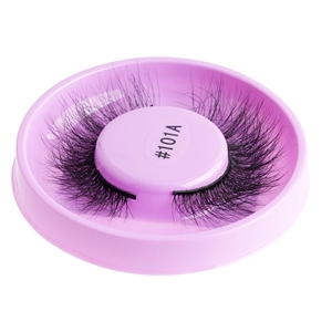 Close-up of thick curly black false eyelashes in a pink round storage case #101A