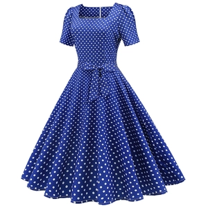 Detailed view of royal blue polka dot dress with square neckline and waist tie