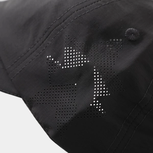 Detailed close-up of laser-cut star ventilation holes on black quick-dry nylon baseball cap