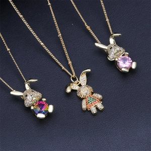 Close-up of rabbit pendant necklaces with colorful cubic zirconia on black leather