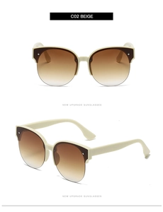 Detail view of beige cat-eye sunglasses with gradient lenses and decorative rice studs