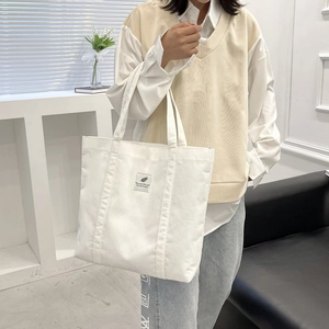 Large capacity white corduroy tote bag with minimalist shoulder straps and label