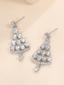 Macro detail of silver Christmas tree earrings with sparkling colorful rhinestones