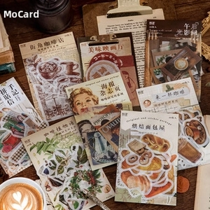 Detail shot of vintage aesthetic stickers for DIY journaling on dark rustic wood