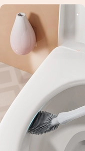 Close-up of flexible gray silicone toilet brush head cleaning inside the bowl rim
