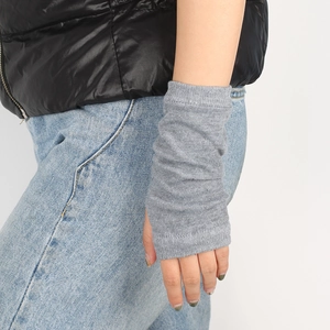 Detail of grey knitted fingerless arm warmers with fine vertical ribbed texture