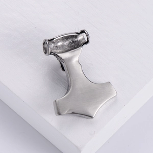 Retro stainless steel Mjolnir pendant with vintage silver finish on white wood surface