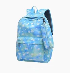Detail of light blue backpack with white star print and matching small pouch bag