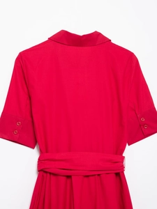 Detailed front view of a red poplin dress featuring a matching waist belt and lapel collar