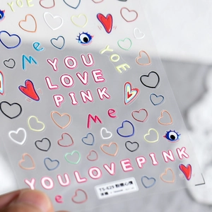 Macro detail of 3D embossed heart and floral nail art stickers with TS-523 label