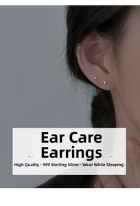 Detail view of four minimalist 999 sterling silver stud earrings on a model ear