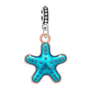 Detailed view of starfish jewelry charm with blue enamel and rose gold trim