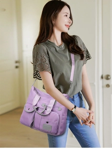 Purple waterproof nylon shoulder bag with multiple pockets and adjustable strap for women