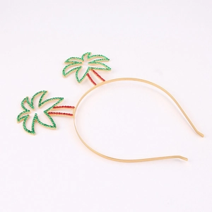 Detail of golden headband with tropical coconut trees in red and green rhinestones
