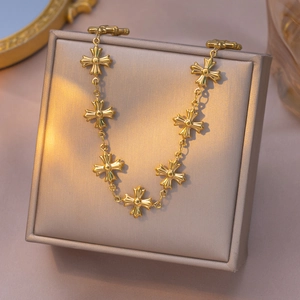 Byzantine style gold cross bracelet on jewelry box with elegant warm lighting
