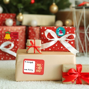 Christmas gift labels with To From design on wrapped boxes under a lit Christmas tree