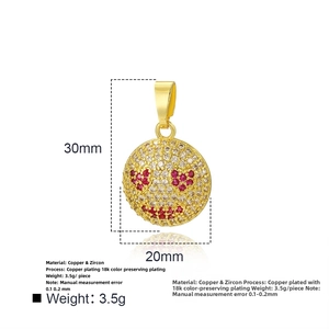 Détail du pendentif visage souriant plaqué or 18 carats avec yeux coeur rouge et zircons