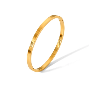 Detail view of the hinge closure and polished gold finish on the stainless steel bangle