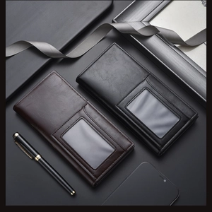 Close-up of leather men's long wallet with ID window among business accessories