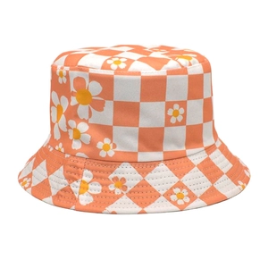 Close-up of orange checkerboard fisherman hat with yellow daisy floral prints