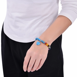 Detail of 8mm blue turquoise beads bracelet with rainbow stones and heart pendant on wrist