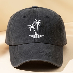 Detail of white embroidered coconut tree on vintage washed black cotton baseball cap