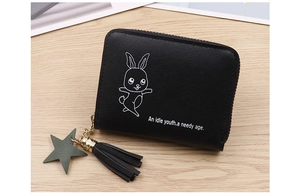 Close-up of black leather coin purse with cartoon rabbit print and star tassel detail
